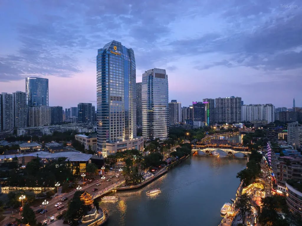 Chengdu city skyline at dusk with the Shangri-La Hotel and Anshun Bridge over the Jin River.