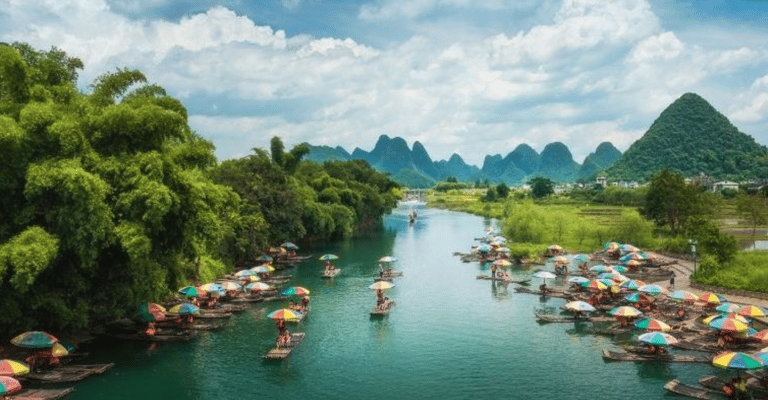 Traditional bamboo rafts with colorful umbrellas on the Yulong River in Yangshuo, China, with karst mountains.
