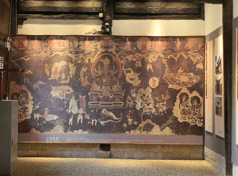 Ancient Buddhist mural inside the Baoshan Temple museum featuring ornate religious art and traditional iconography.