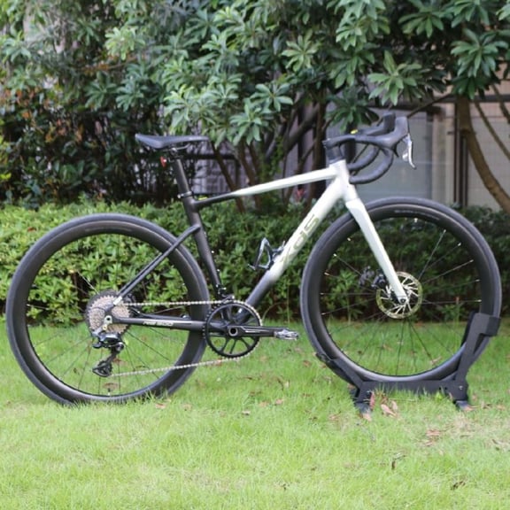 XDS RS500 road bike parked on a green lawn with carbon wheels and disc brakes.