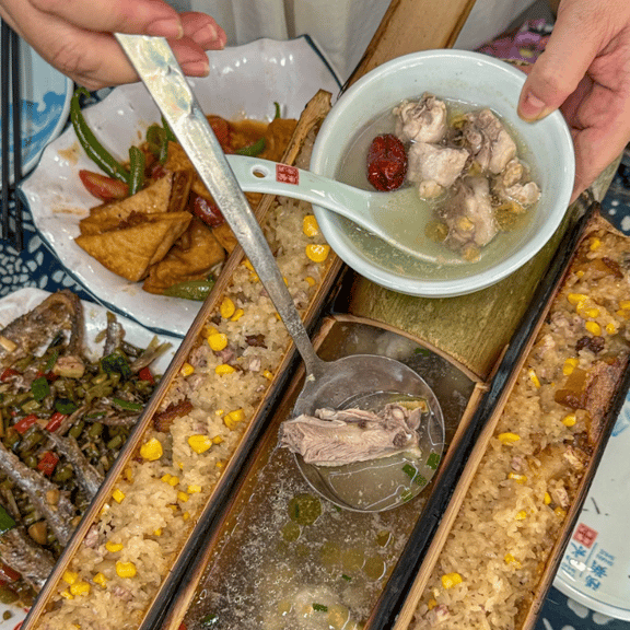 Traditional bamboo rice and chicken soup served in bamboo tubes with assorted Chinese side dishes.