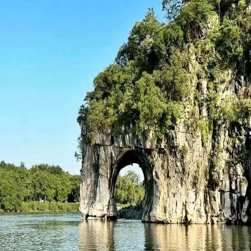 Elephant Trunk Hill limestone formation on the Li River in Guilin China under a clear blue sky.