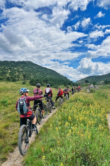 Cyclist riding the Boduoluo line through alpine forest near Wenhai Lake