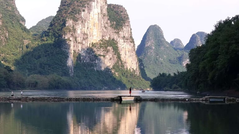 Scenic karst mountains reflected in the calm waters of the Li River in Guilin, China.